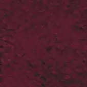 Burgundy fabric swatch displaying a dense, mottled texture with tonal variations ranging from dark brown to vibrant red hues, even diffused lighting.